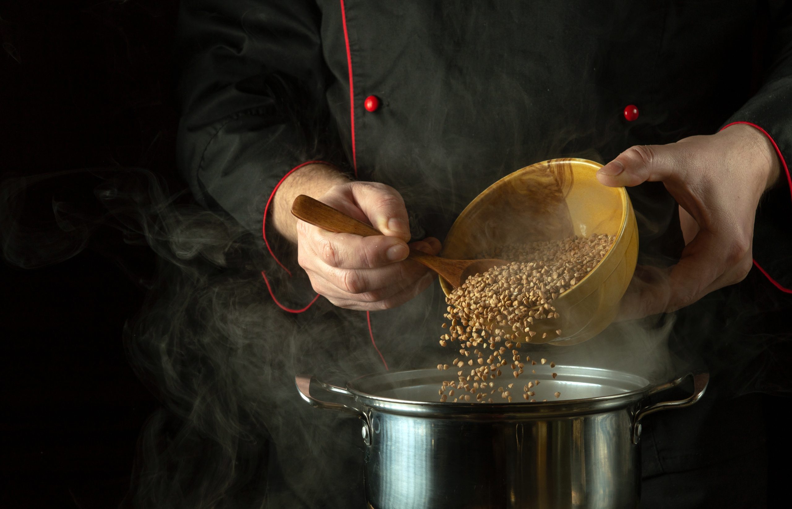 The,Cook,Pours,Dry,Buckwheat,Into,The,Pan,With,A