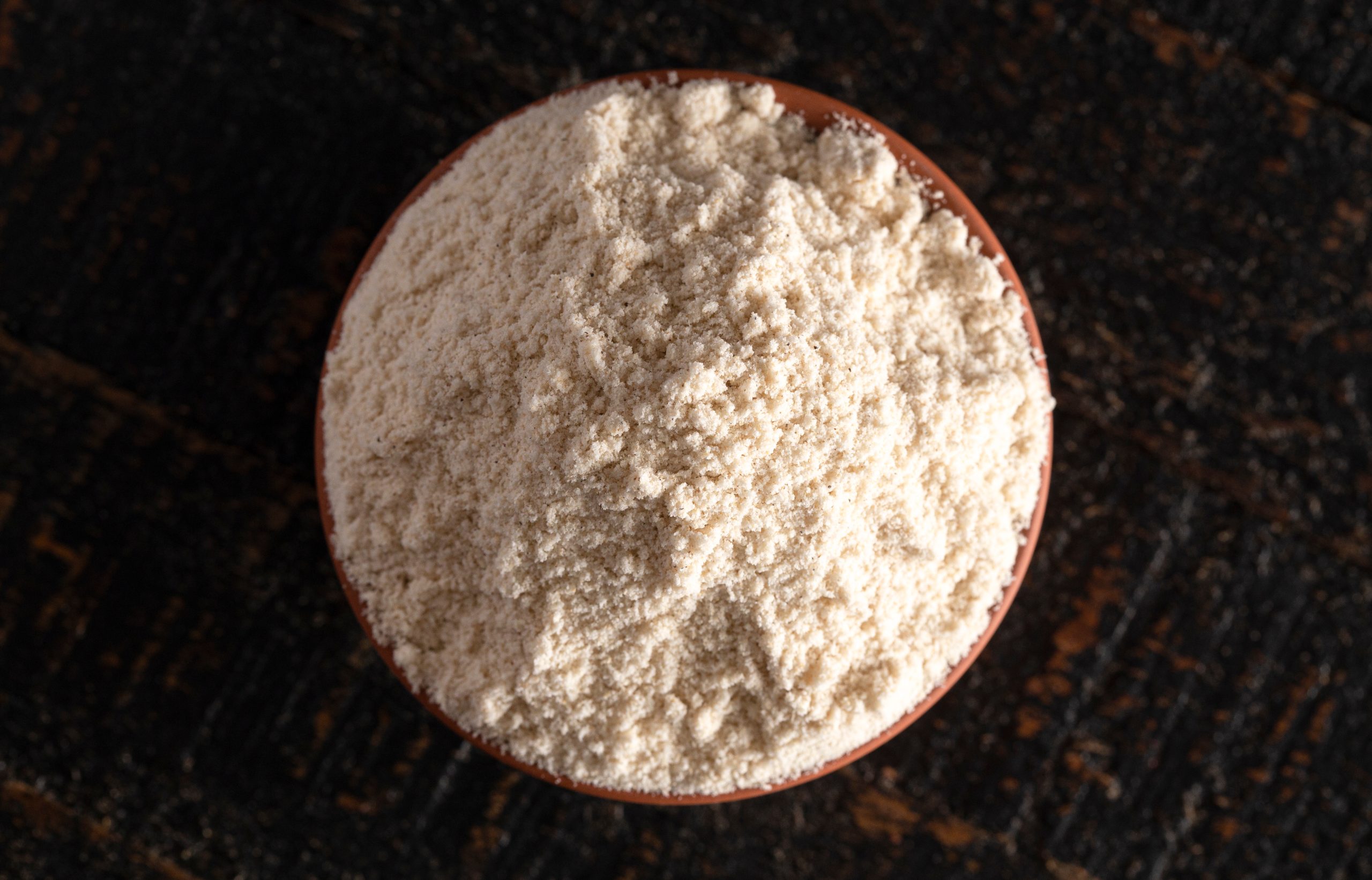A,Bowl,Of,Sprouted,Sorghum,Flour,On,A,Dark,Wood