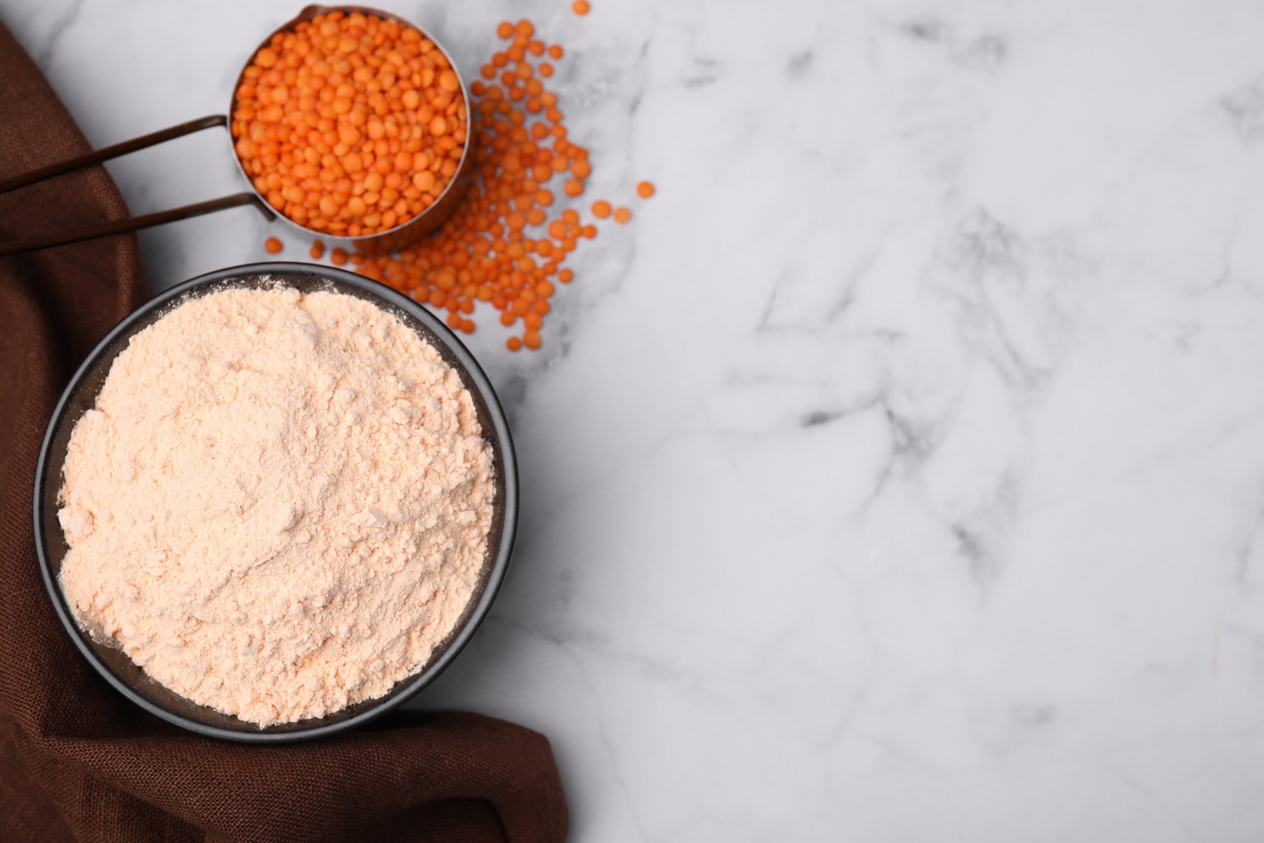 Lentil,Flour,And,Seeds,On,White,Marble,Table,,Flat,Lay.