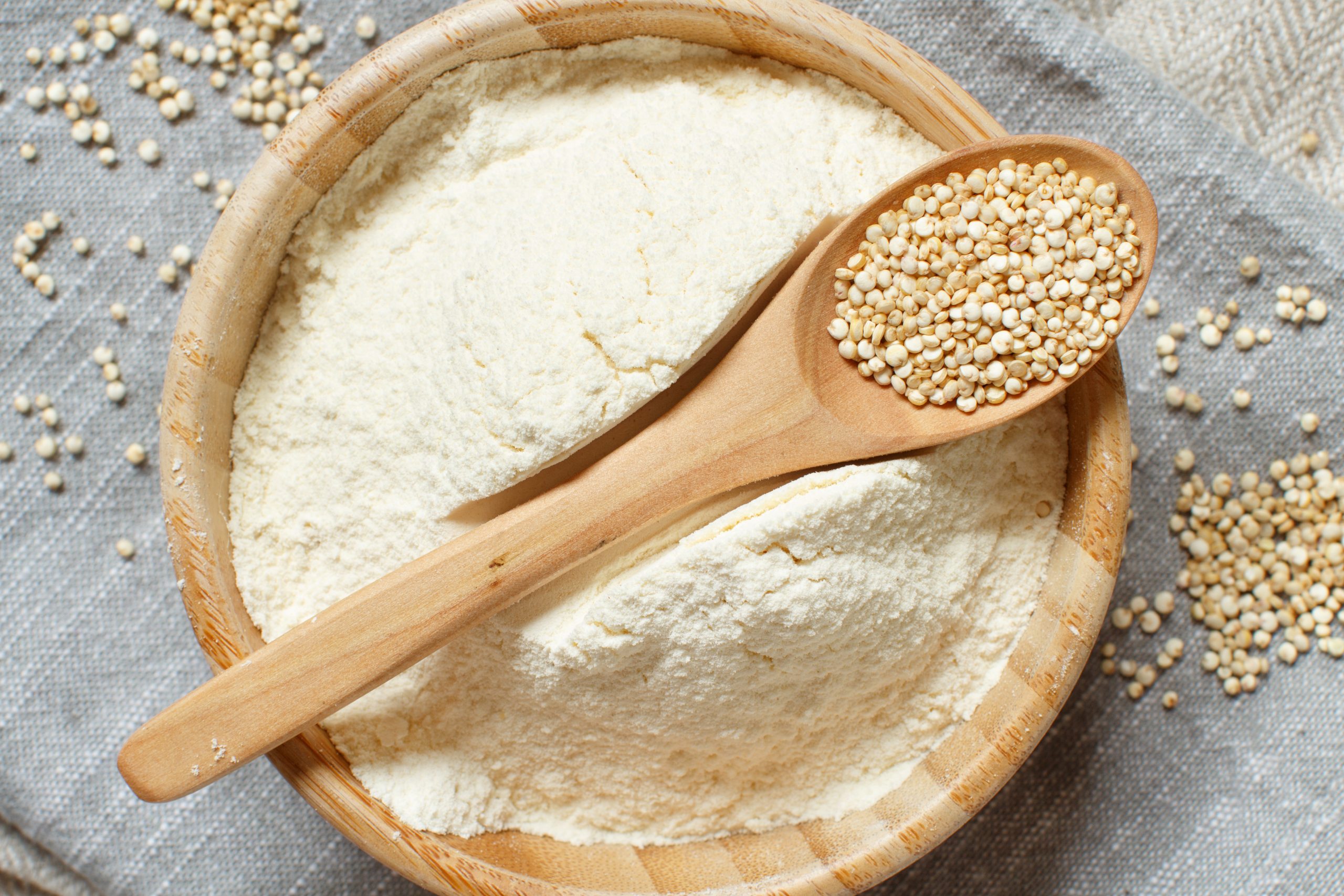Raw,White,Quinoa,Seeds,And,Flour,On,A,Grey,Napkin
