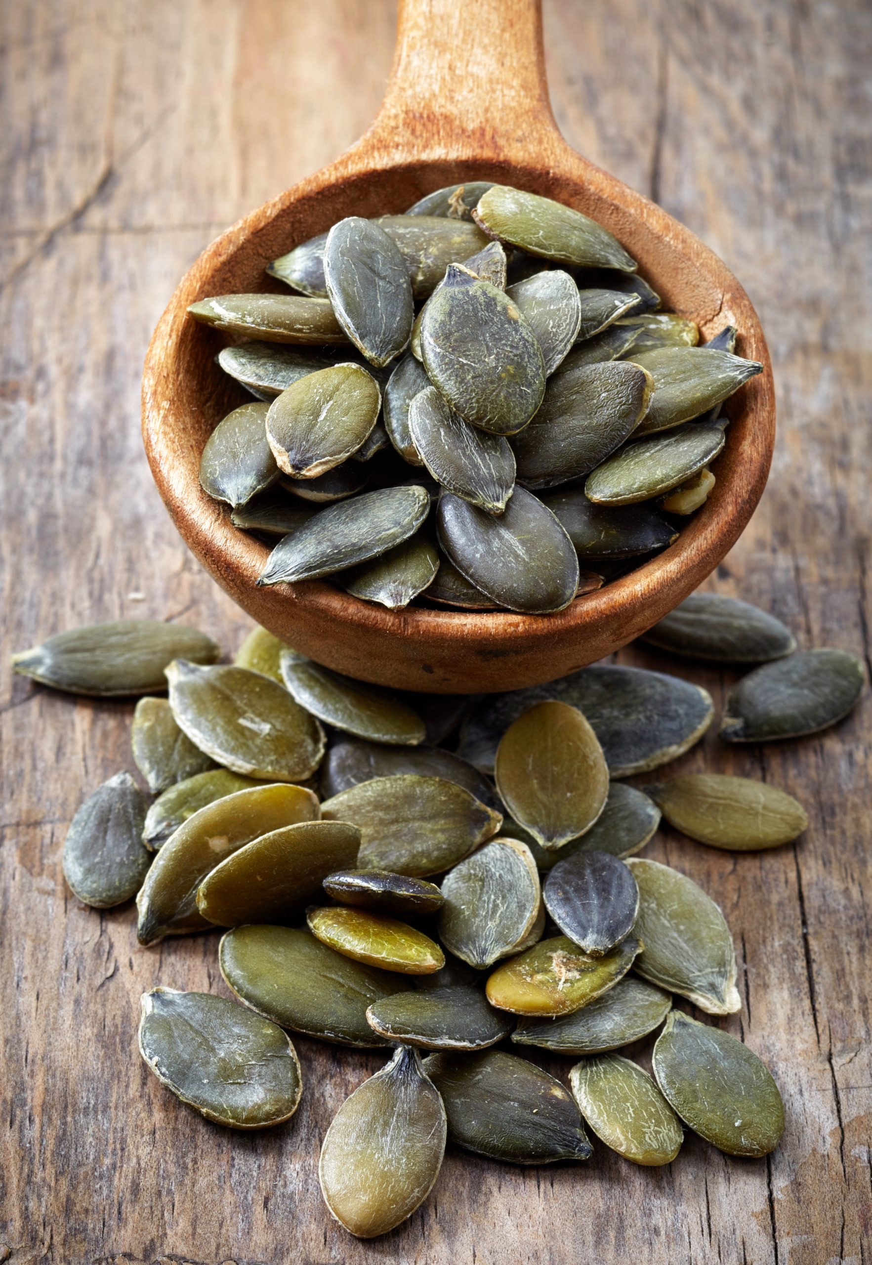 Spoon,Of,Squash,Seeds,On,Old,Wooden,Table,Background